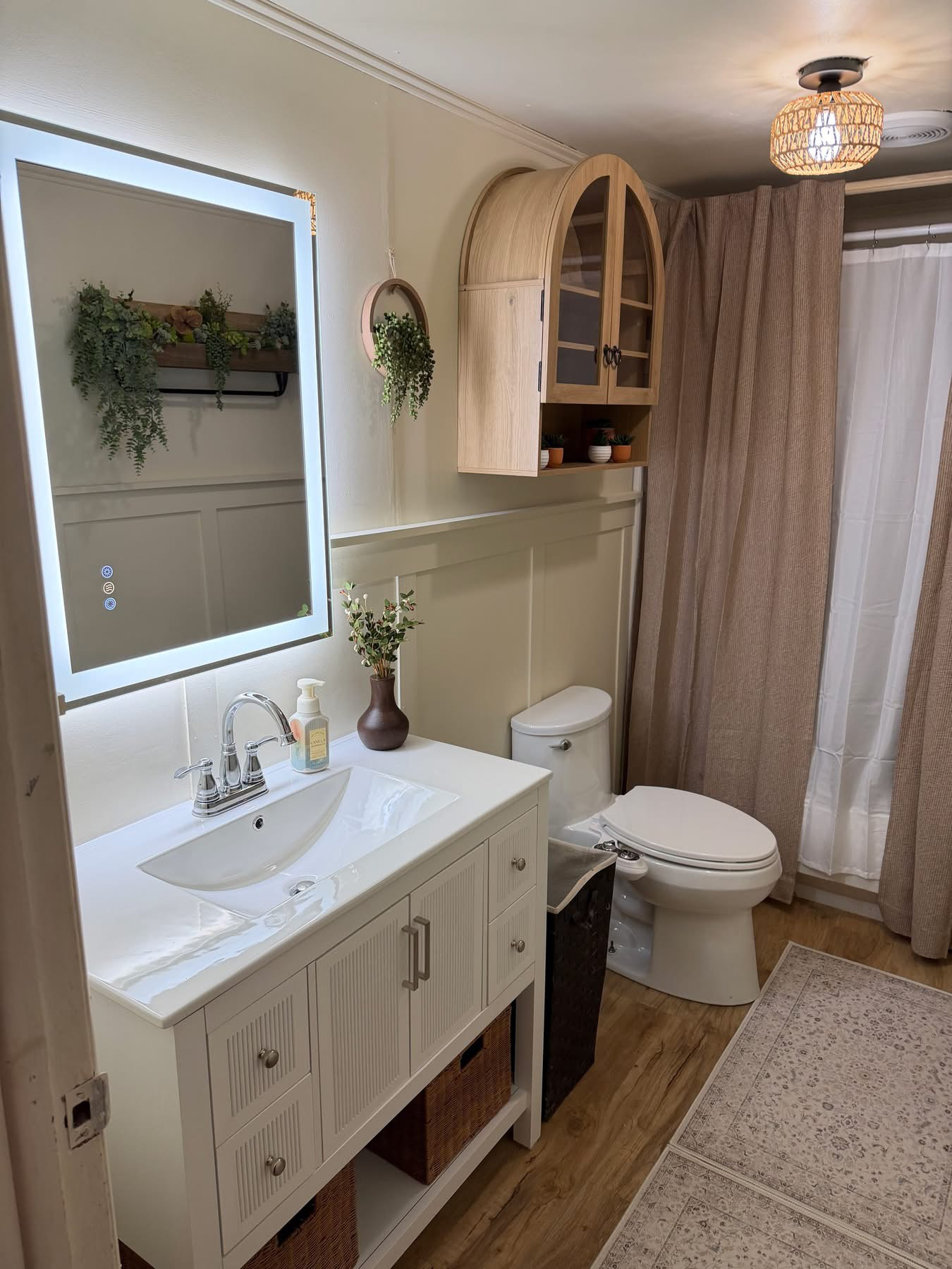 After — Bathroom with refinished ceiling, arched cabinet, and new vanity