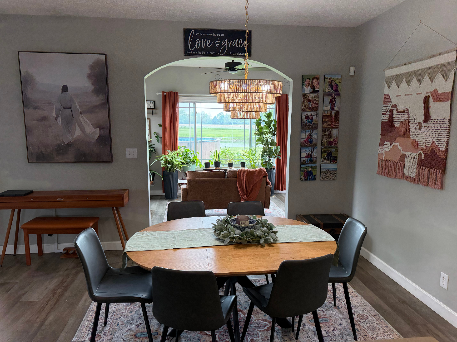 After — Dining room and sunroom styled with layered art, woven chandelier, gallery wall, and warm textiles