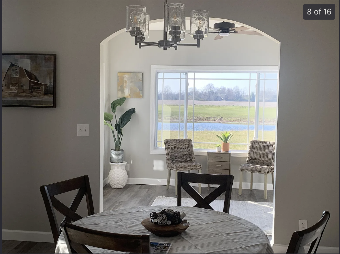 Before — Dining room and sunroom styled with layered art, woven chandelier, gallery wall, and warm textiles