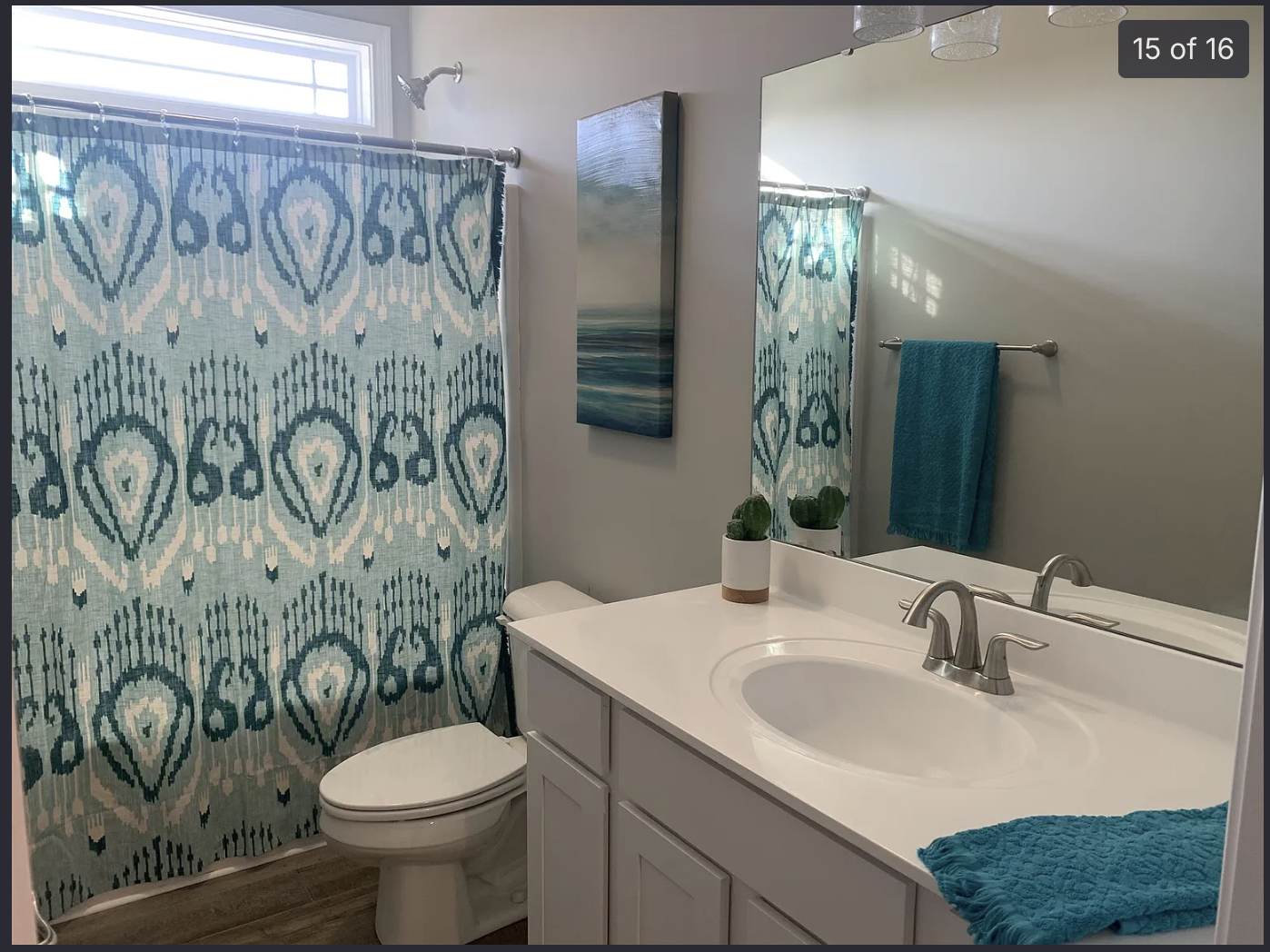 Before — Main bathroom transformed with warm mocha walls, wood vanity, marble counter, and arched storage