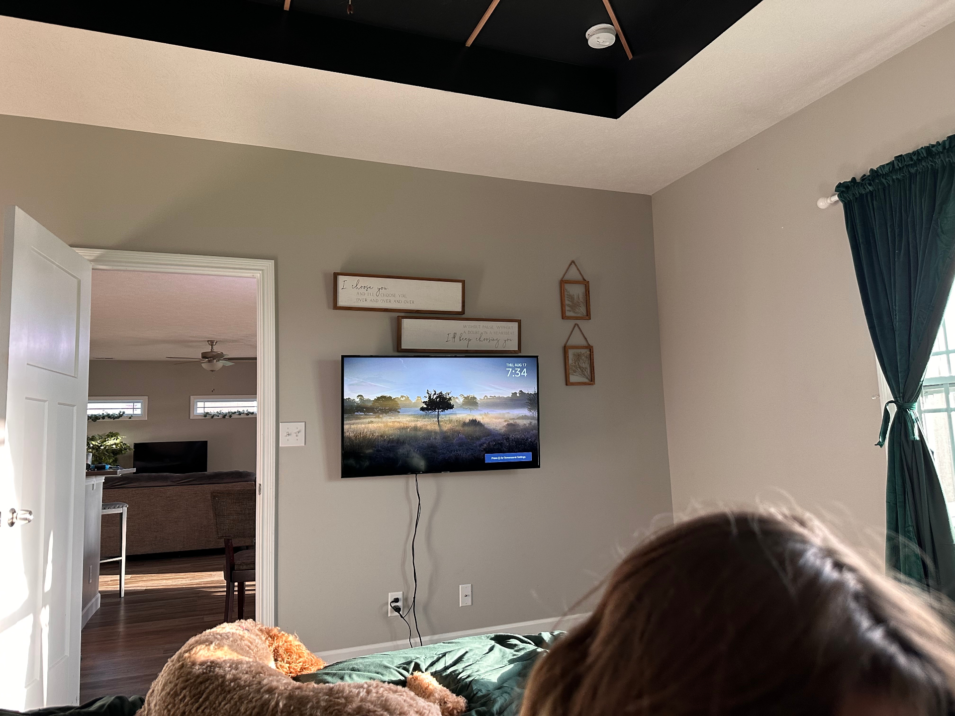 Before — Master bedroom feature wall with navy shiplap fireplace, built-in shelving, and curated styling